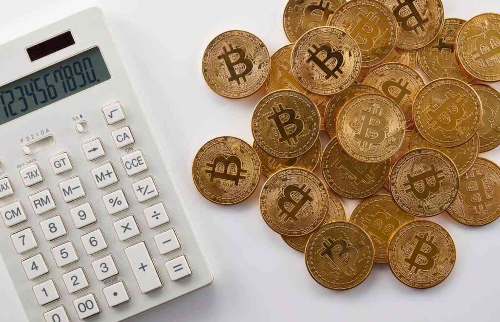 "Bitcoin coins with calculator showing cryptocurrency calculation concept"